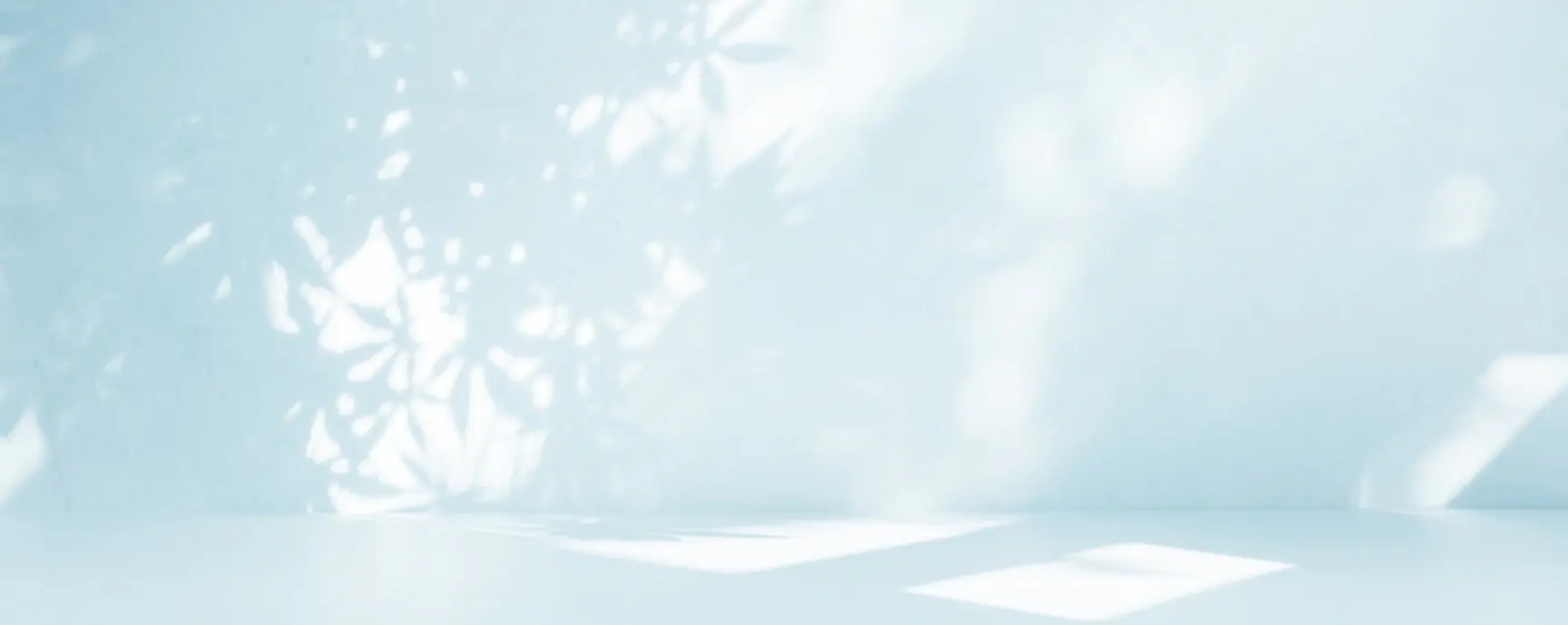 sunlight shining on a wall in a blue room.