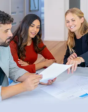 agent going over some paperwork with a couple