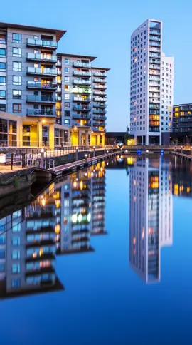 skyscrapers reflecting in a pond