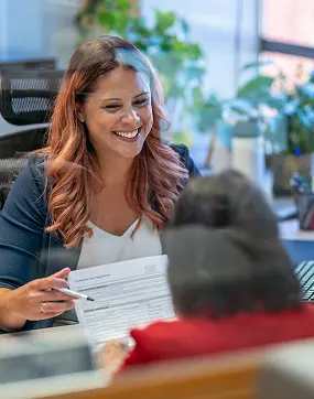 women smiling doing paperwork