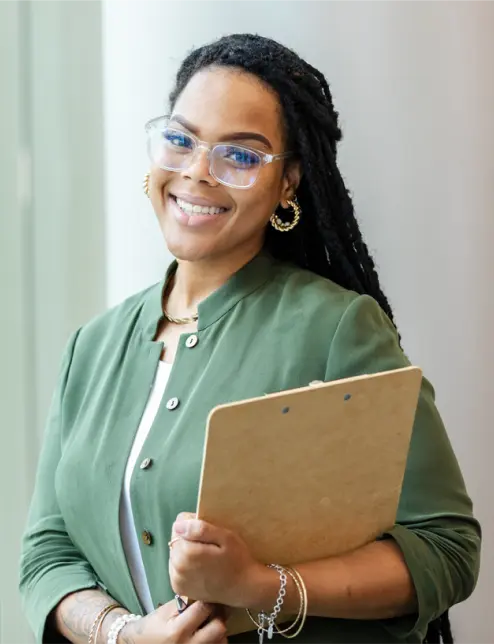 Person smiling whilst holding a clipboard