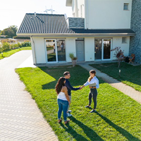 people on a lawn, shaking hands